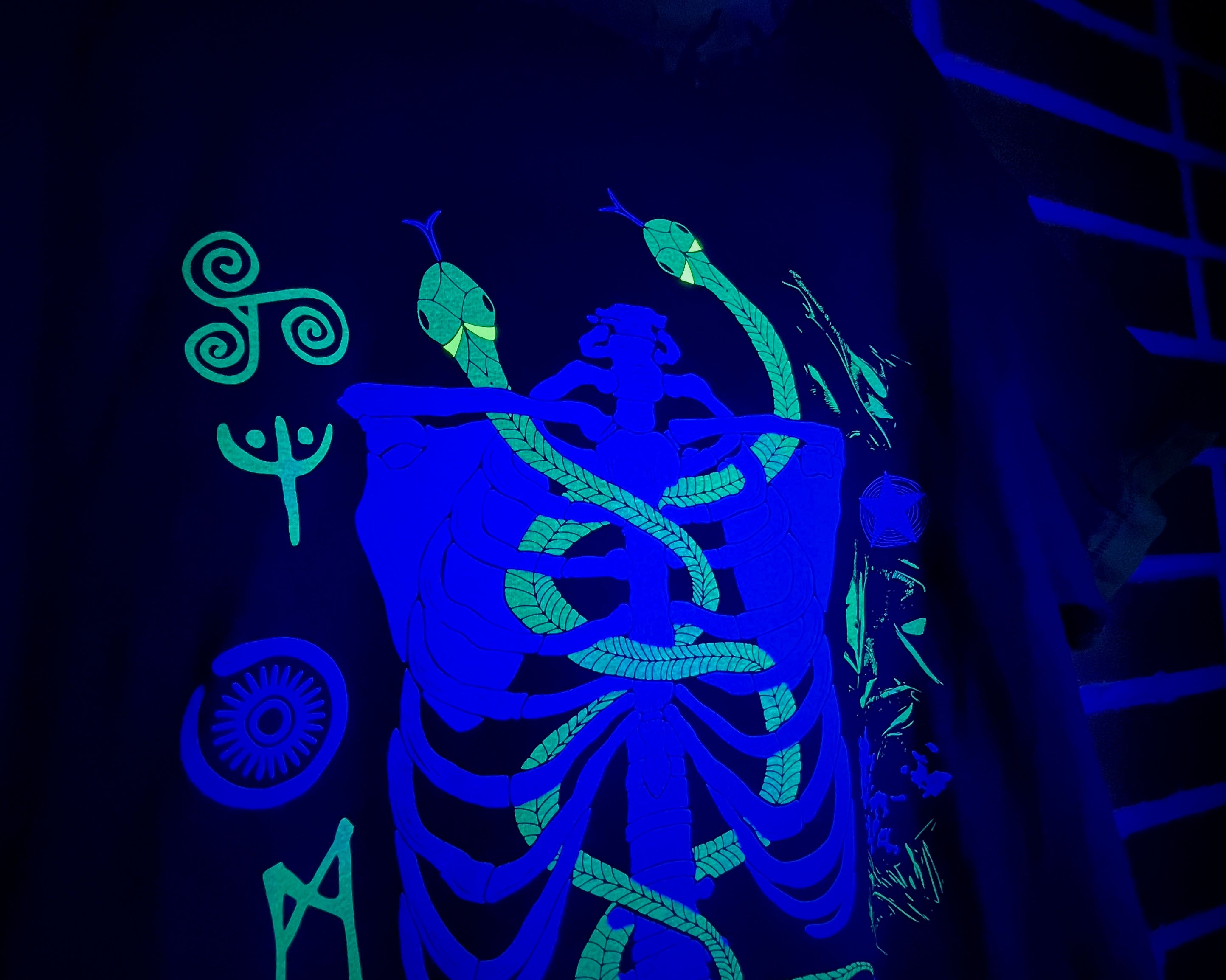Glowing blue and green design on a dark background