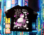 Black t-shirt with a unique design in front of colorful bookshelves