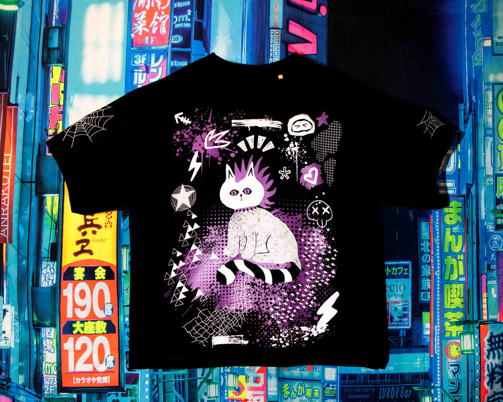 Black t-shirt with a white cat design on a colorful cityscape background