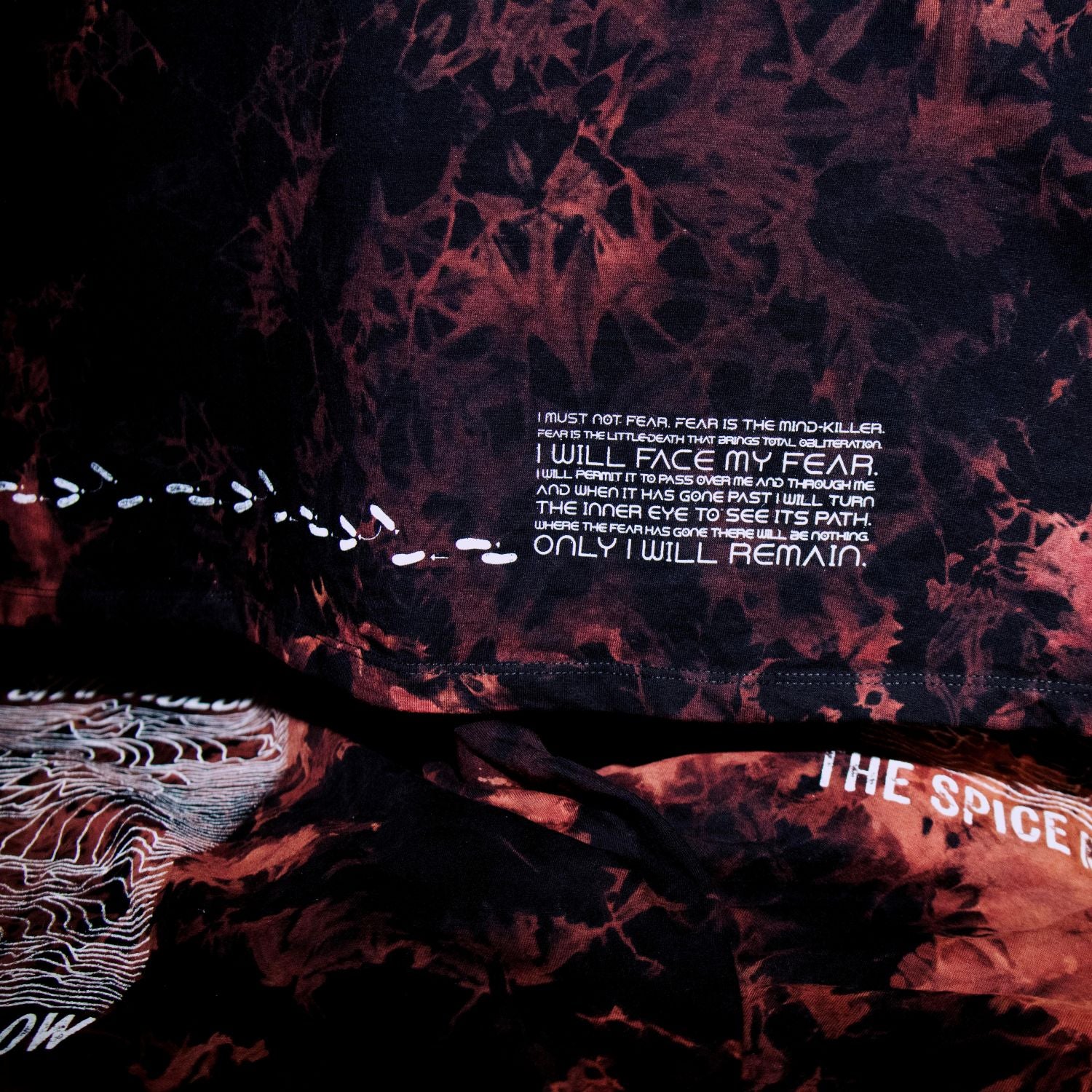 Tie-dye hoodie with text on a dark background
