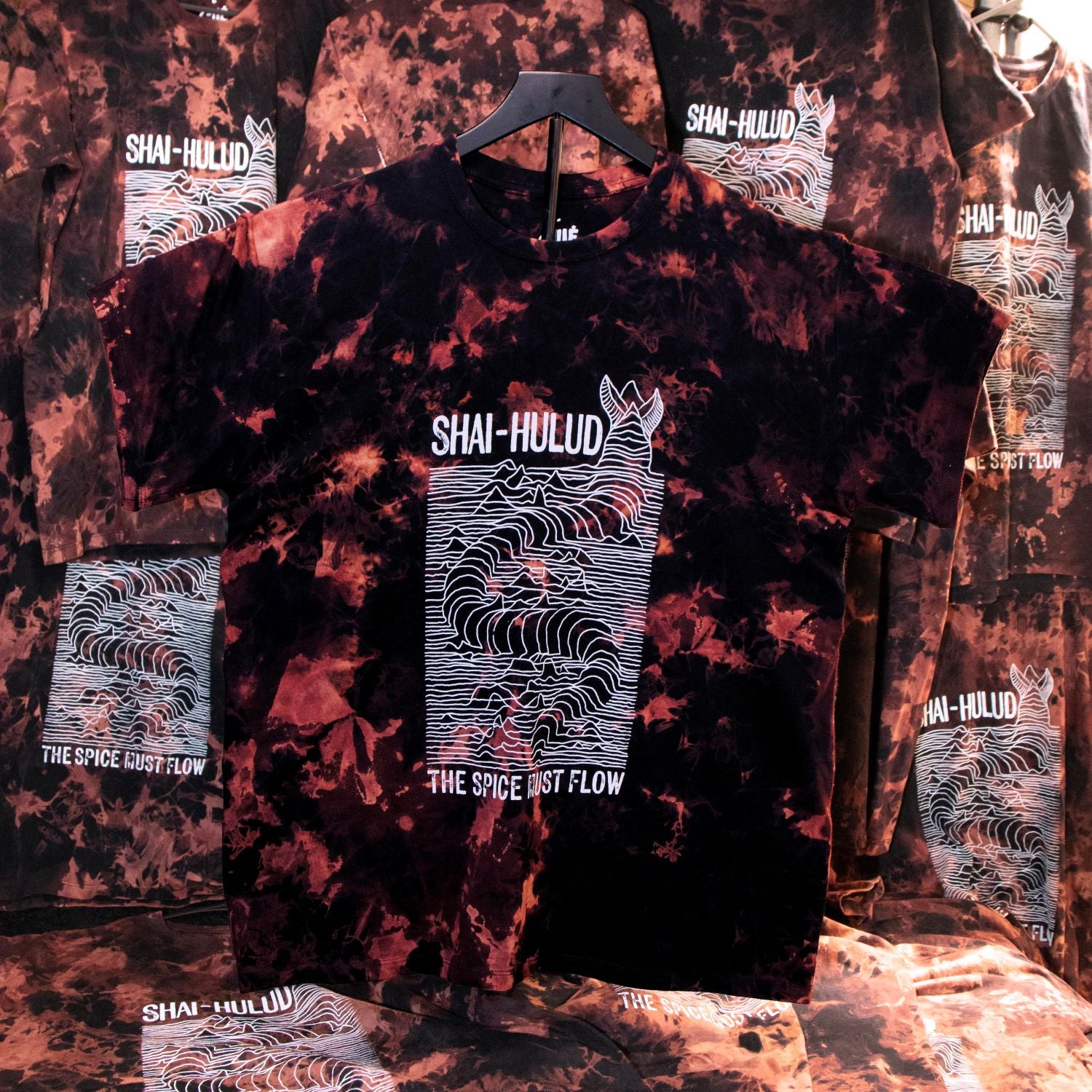 Tie-dye t-shirt with 'Shai-Hulud' design on a textured background