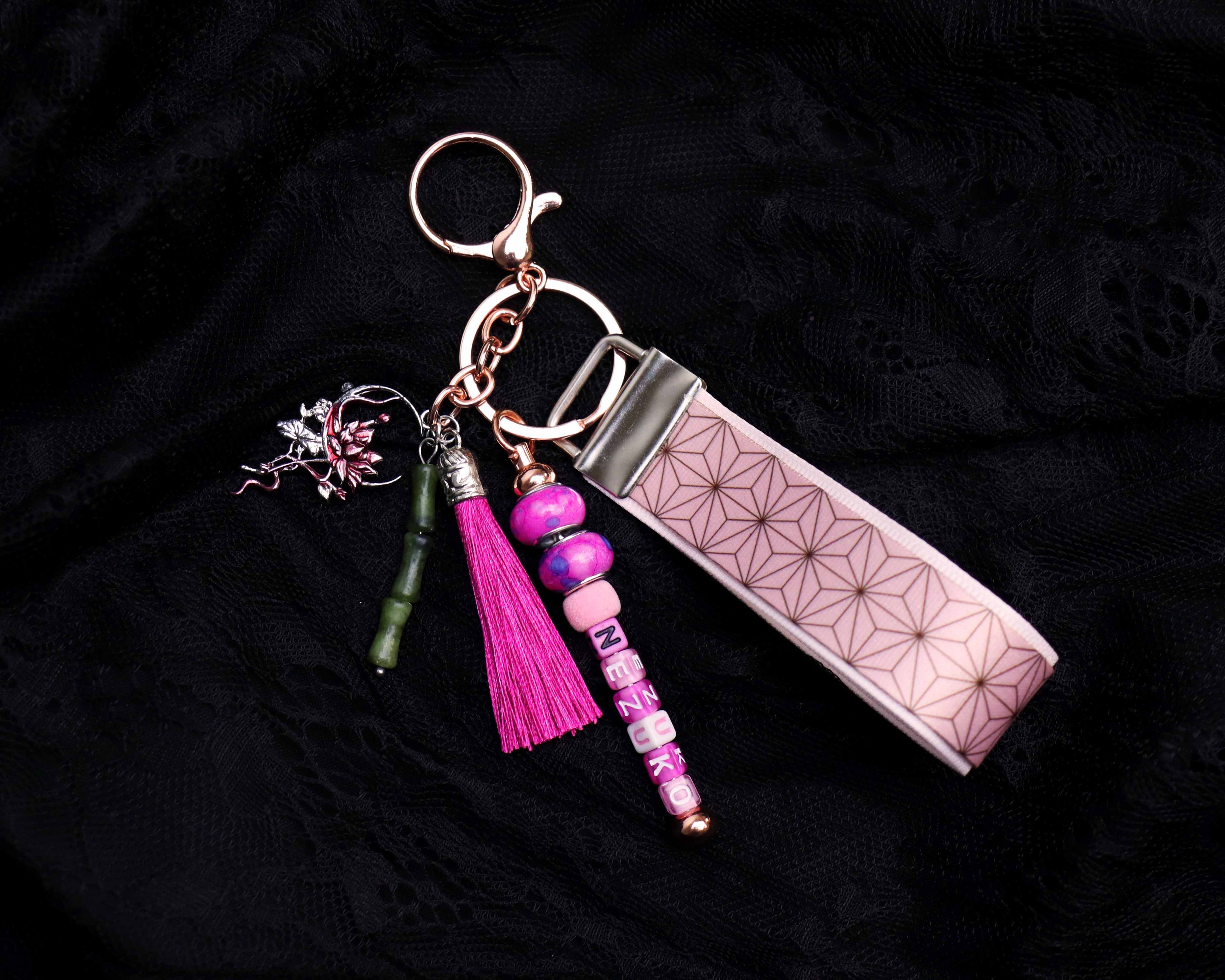Keychain with pink tassel and beads on a black background