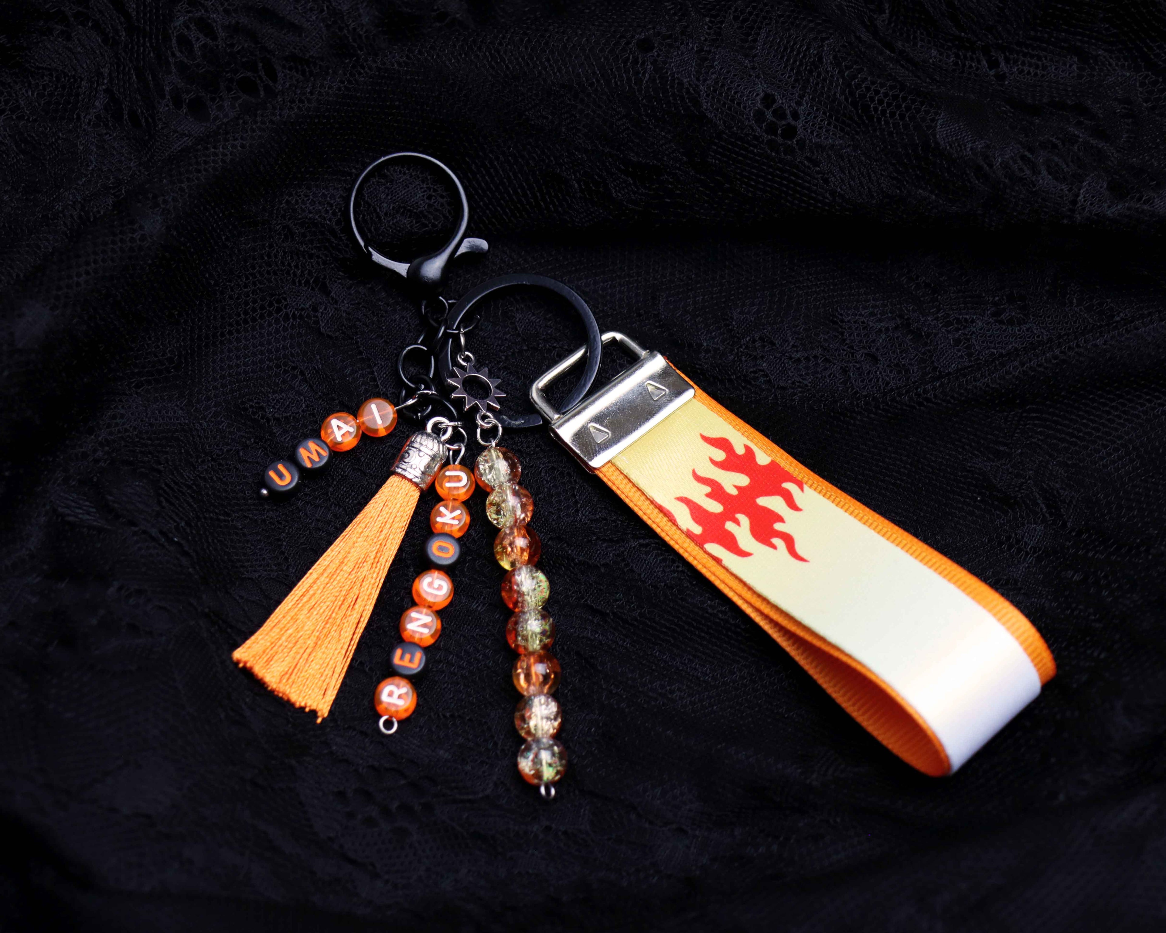 Keychain with orange tassel, beads, and ribbon on a dark background
