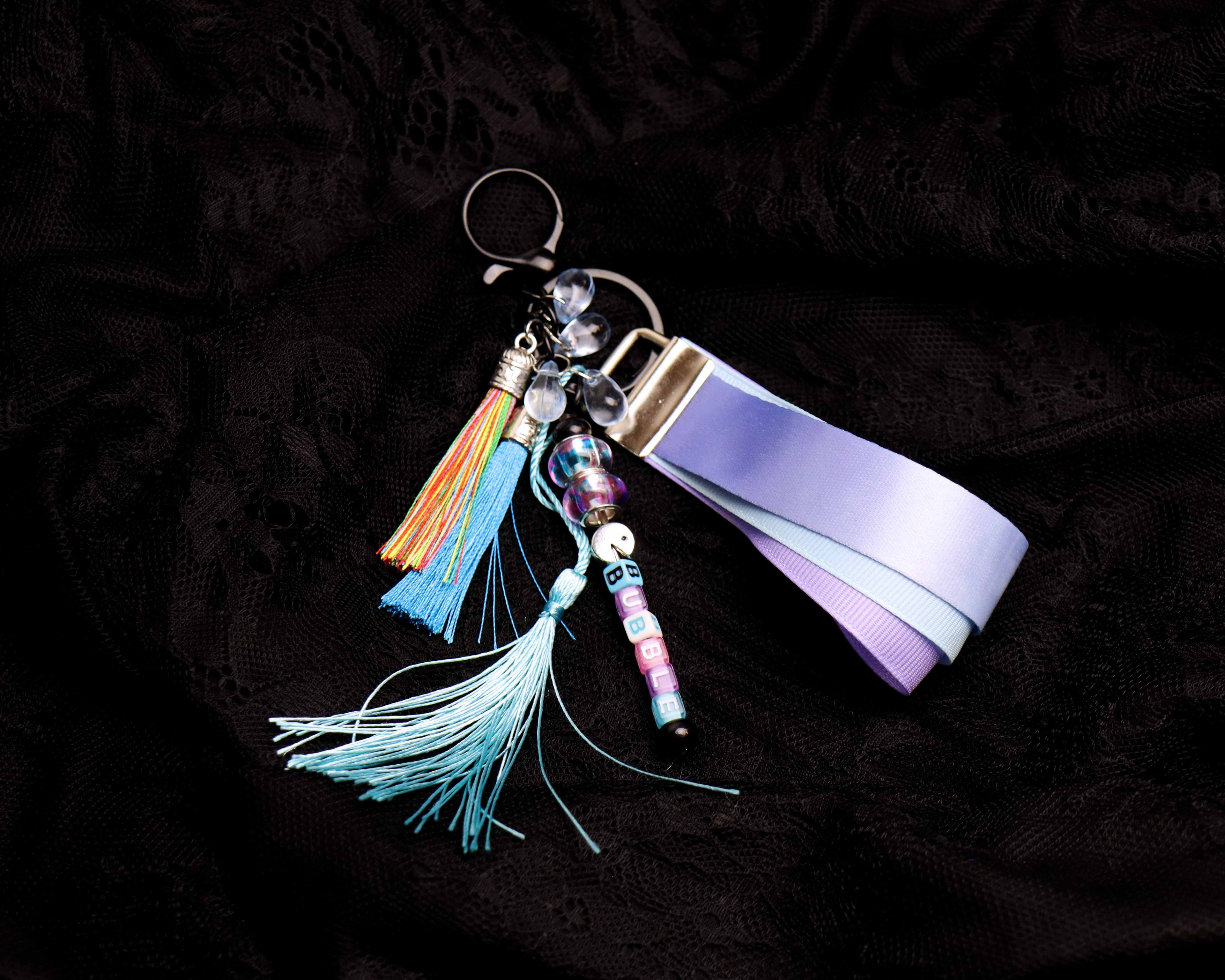 Keychain with colorful tassels and beads on a dark background