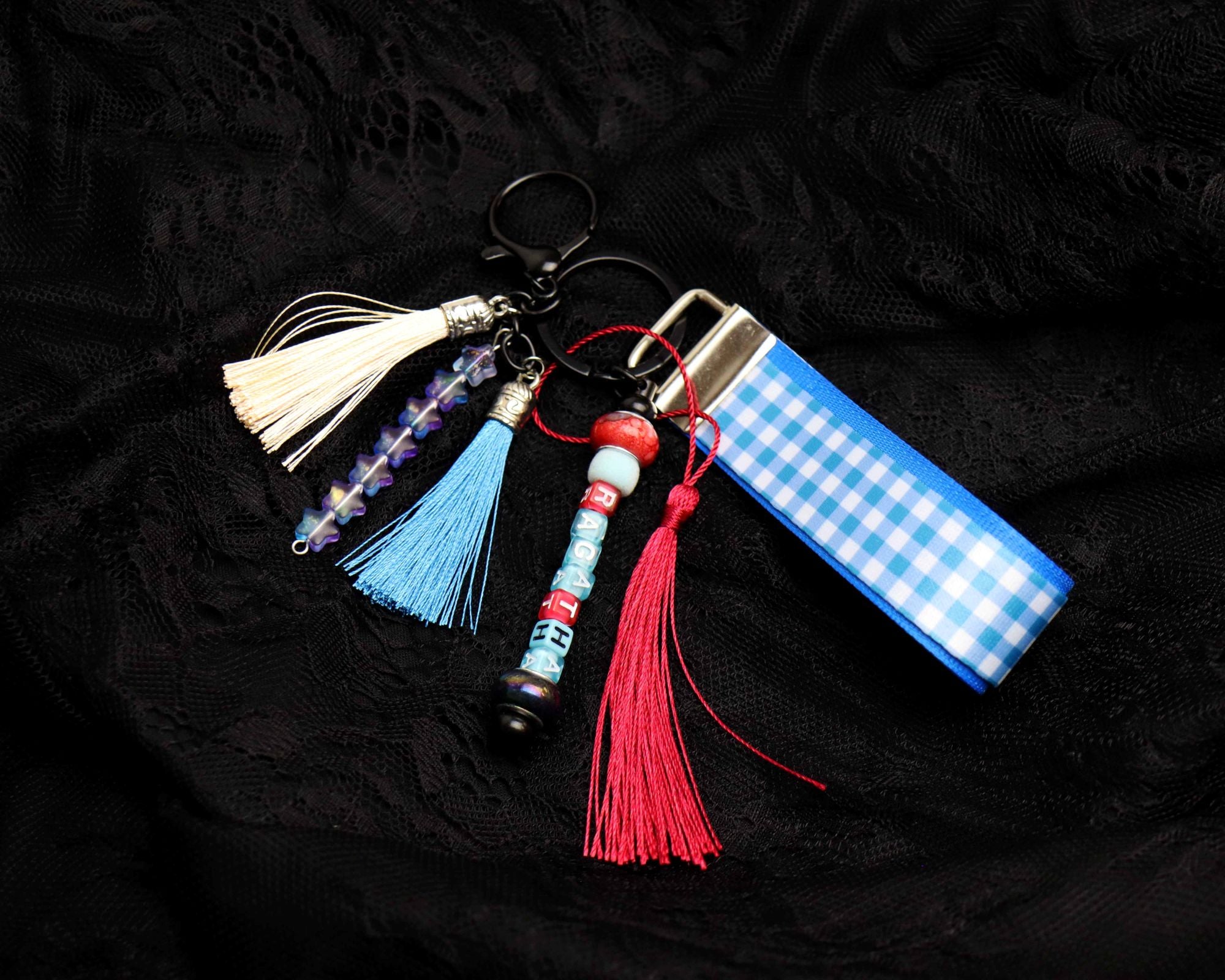 Keychain with tassels and decorative elements on a black background