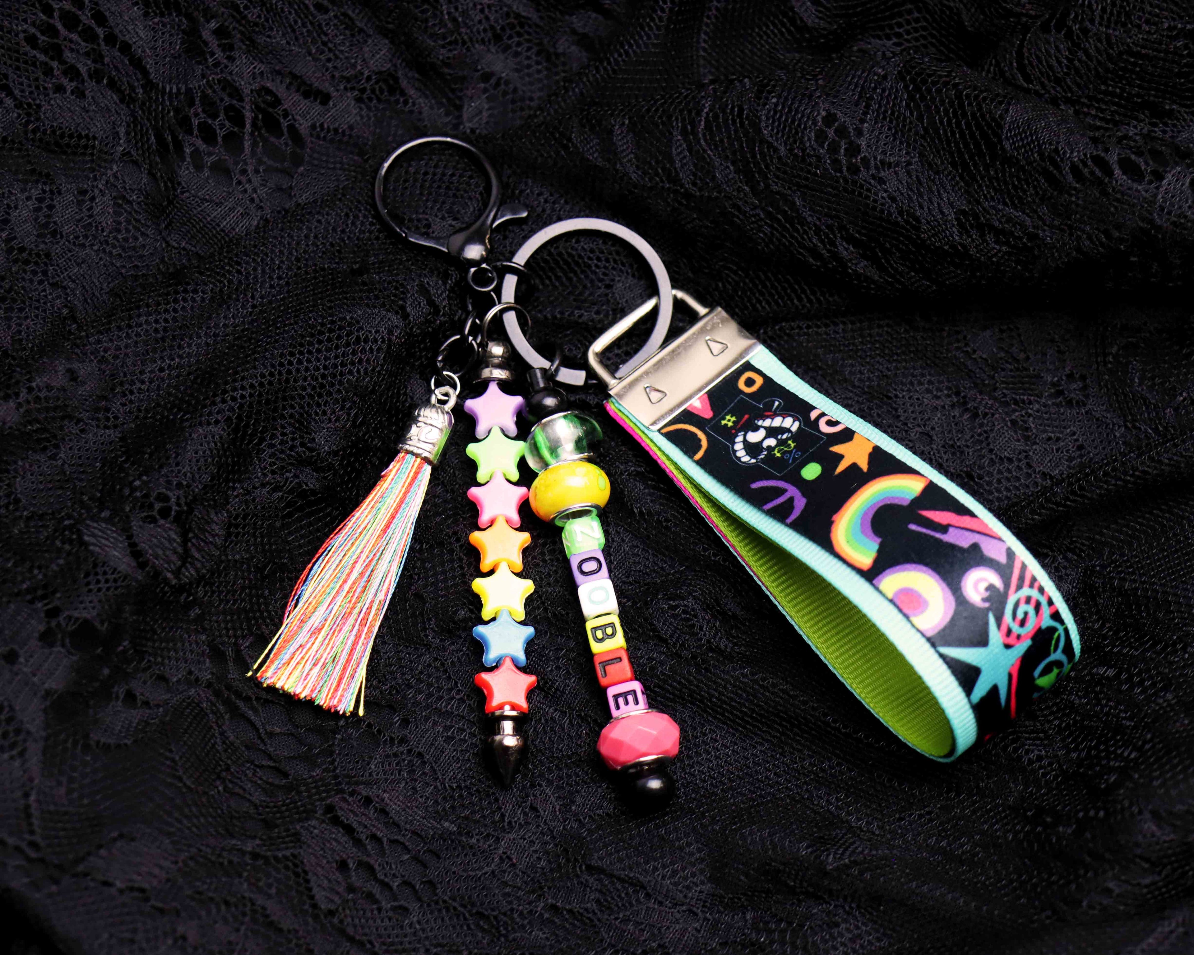 Colorful keychain with tassel and beads on a black textured background